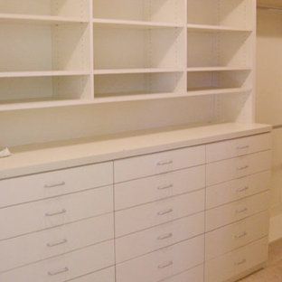A walk in closet with lots of drawers and shelves.