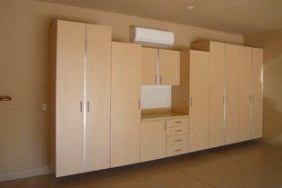 A room with a lot of cabinets and drawers on the wall.