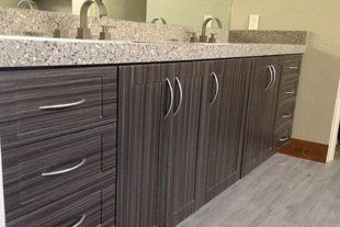 A bathroom with two sinks and a large mirror.