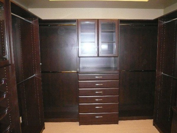 A walk in closet with lots of drawers and shelves