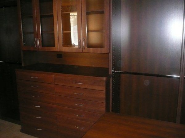 A kitchen with stainless steel appliances and wooden cabinets