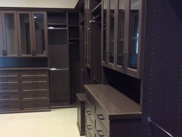 A walk in closet with lots of cabinets and drawers