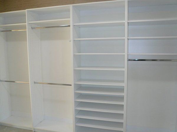 A closet with lots of shelves and clothes racks