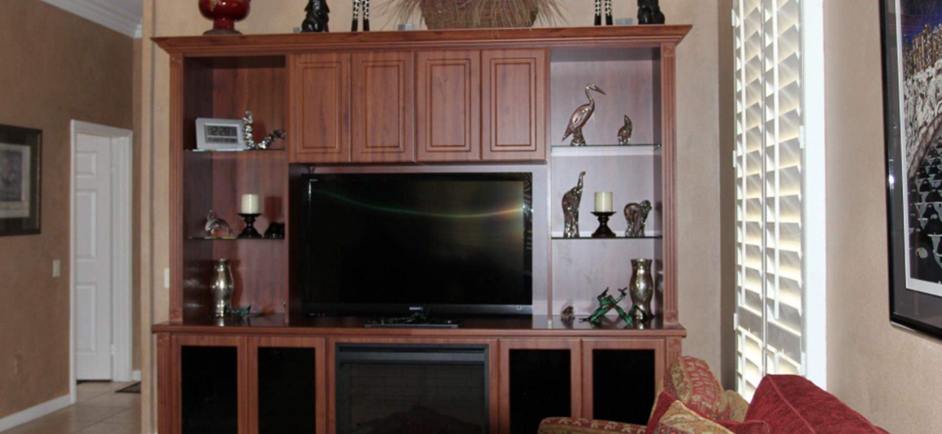 A living room with a fireplace and a flat screen tv