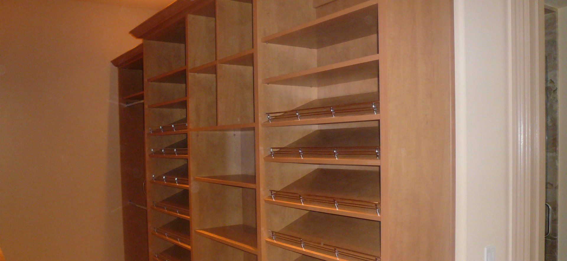 A closet with lots of shelves and a door.