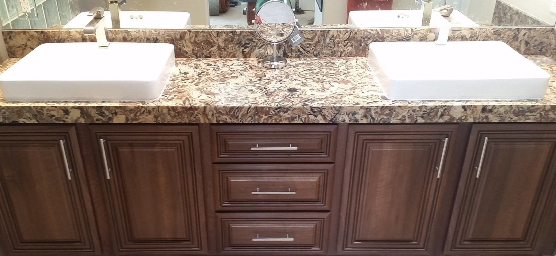 A bathroom vanity with two sinks and a mirror.