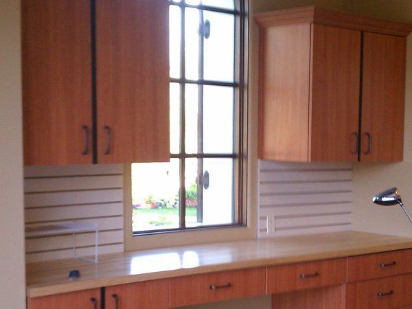 A kitchen with wooden cabinets and a window