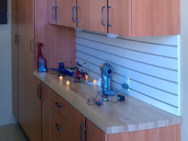 A kitchen with wooden cabinets and a wooden counter top