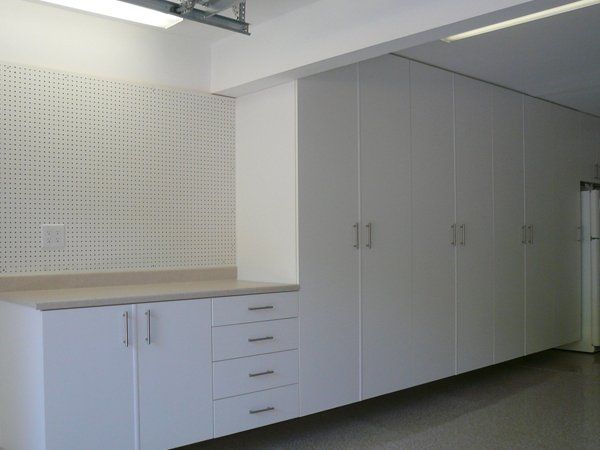 A kitchen with white cabinets and a counter top