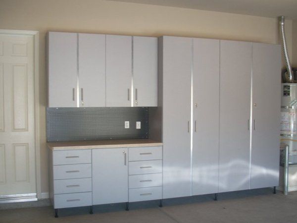 A kitchen with lots of white cabinets and drawers