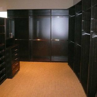 A walk in closet with lots of shelves and drawers
