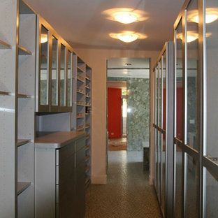 A hallway with lots of shelves and glass doors