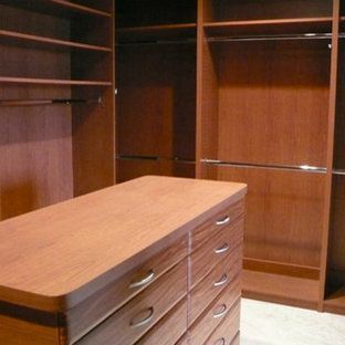 A walk in closet with lots of shelves and drawers