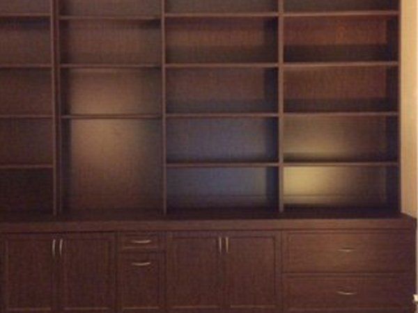 A bookcase with lots of shelves and drawers