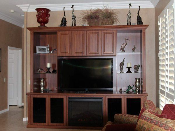 A living room with a fireplace and a flat screen tv