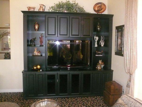 A living room with black cabinets and a flat screen tv