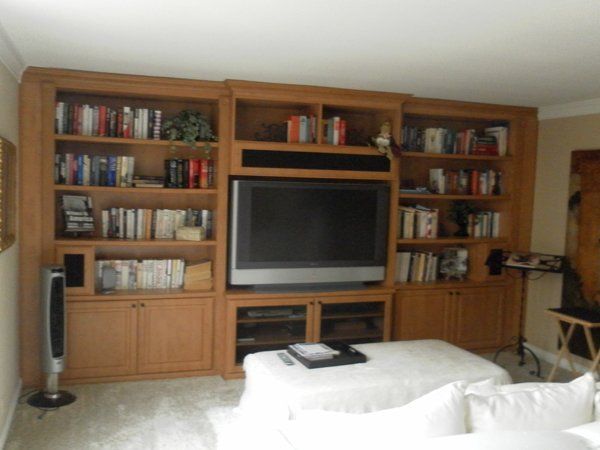 A living room with bookshelves and a flat screen tv