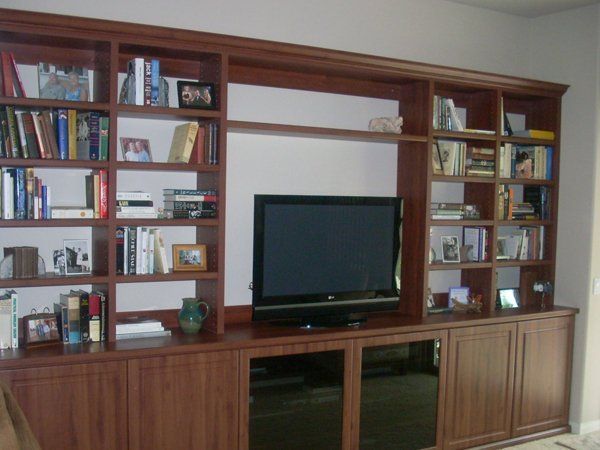 A living room filled with books and a flat screen tv