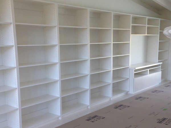 A room with a lot of shelves and a tv