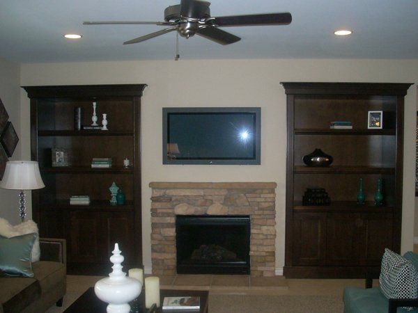 A living room with a fireplace and a flat screen tv