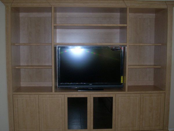 A tv is sitting on top of a wooden entertainment center