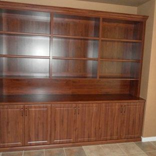 A large wooden bookcase with lots of shelves and cabinets