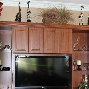 A living room with wooden cabinets and a flat screen tv