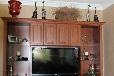 A living room with a tv on top of a wooden entertainment center