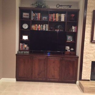 A living room with a wooden entertainment center and a flat screen tv.