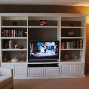 A living room with a large entertainment center and a flat screen tv