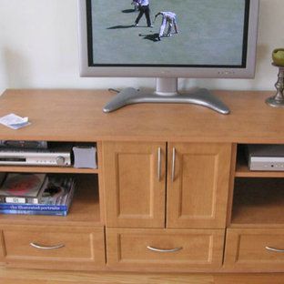 A flat screen tv is sitting on top of a wooden entertainment center
