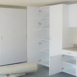 A room with white cabinets and a mattress on the floor.