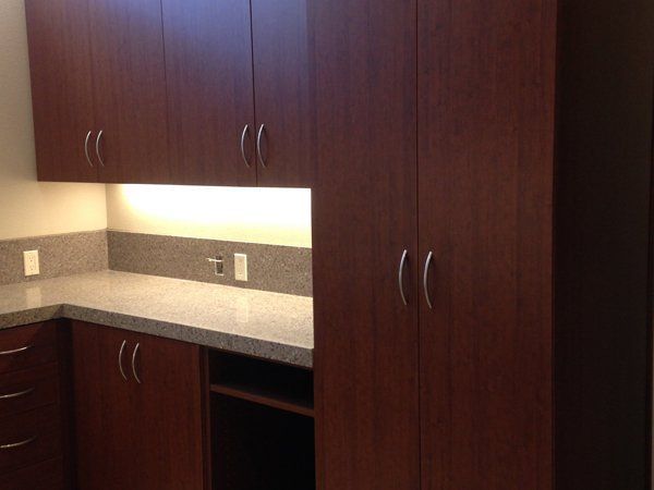 A kitchen with wooden cabinets and a granite counter top