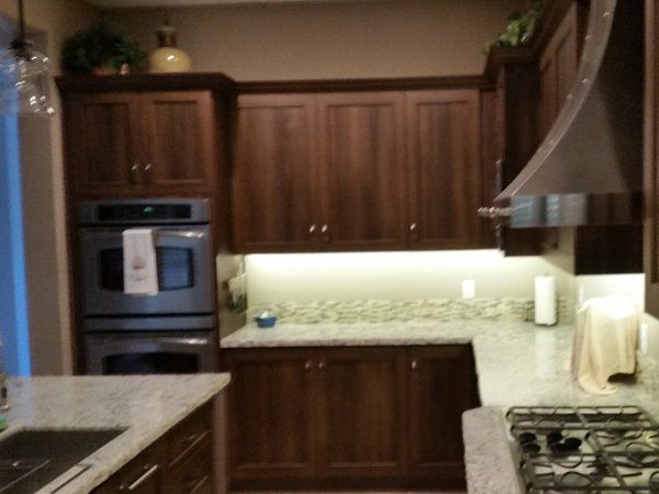 A kitchen with stainless steel appliances and wooden cabinets