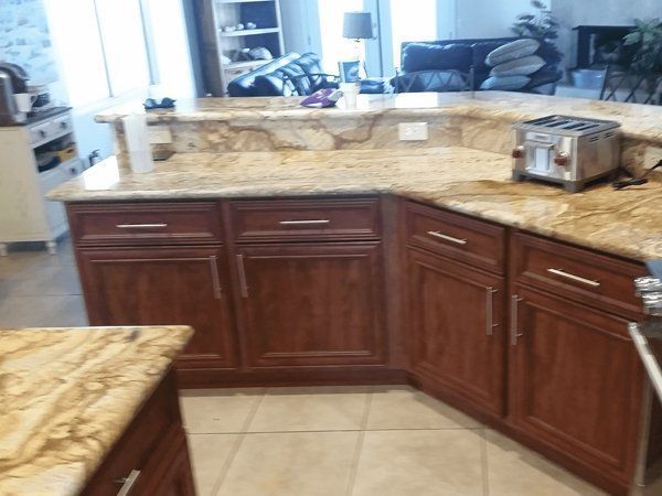 A kitchen with wooden cabinets and granite counter tops