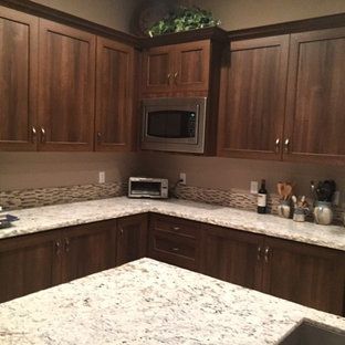 A kitchen with wooden cabinets and granite counter tops.