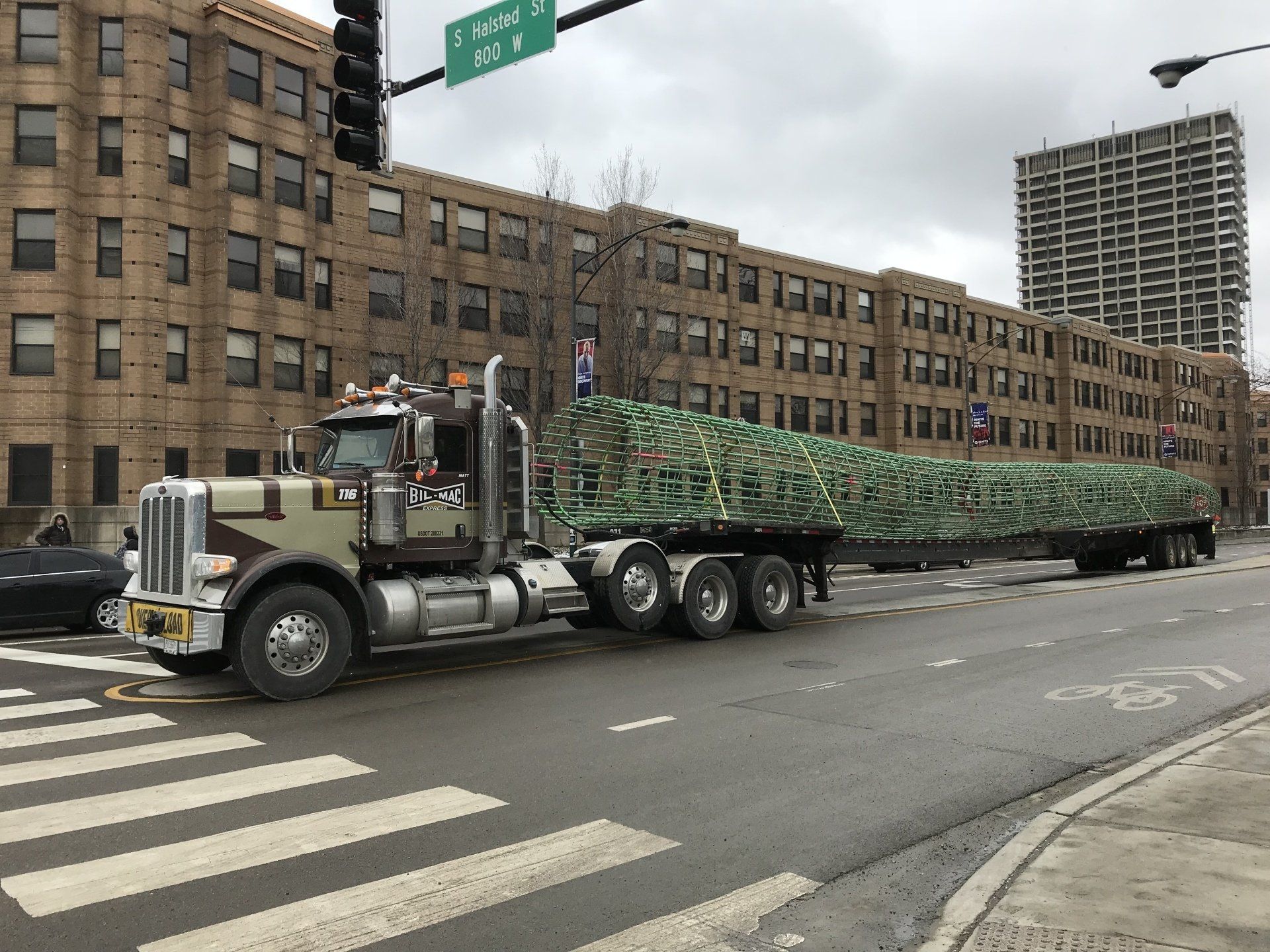 A large semi truck is driving down a city street