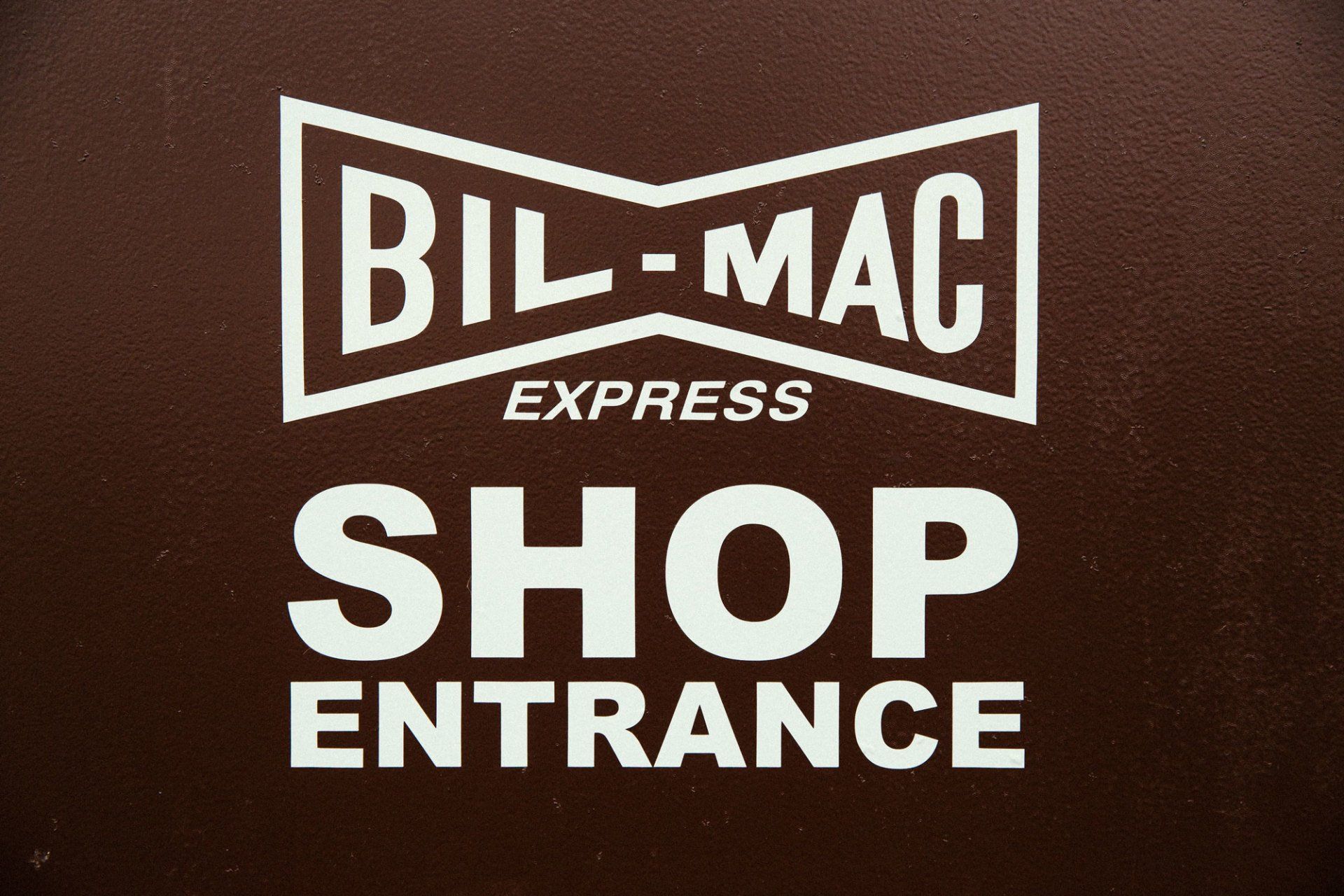 A sign that says bil-mac express shop entrance