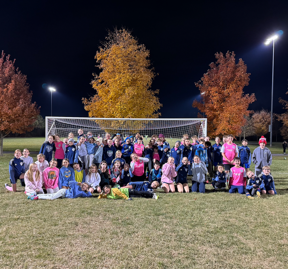 Buckingham United players gathered on the field at a club event