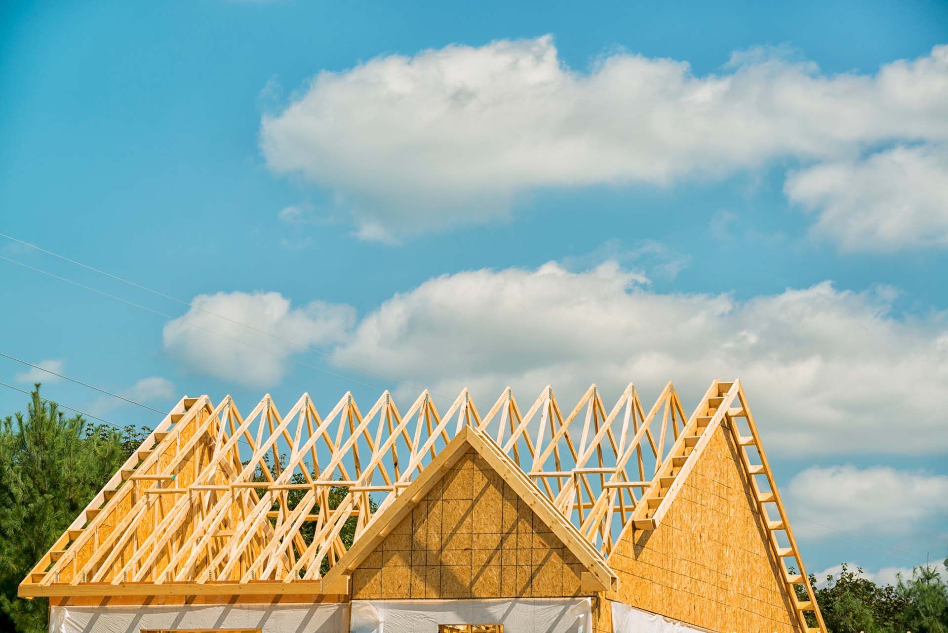 A house is being built with a wooden roof trusses