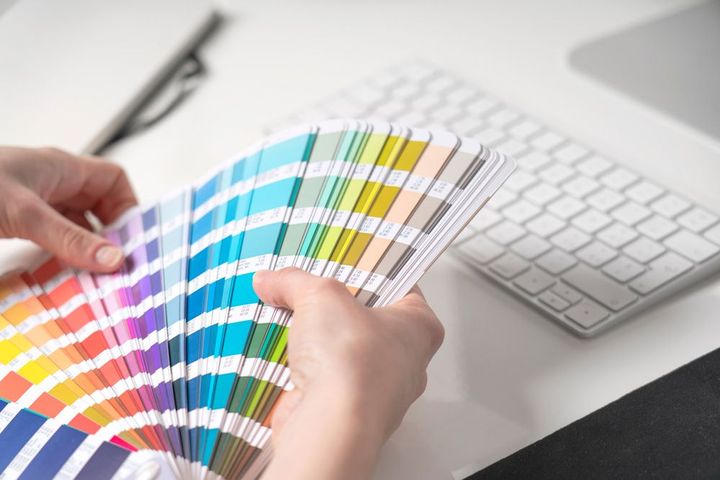 Graphic Designer Choosing Colours From Palette Guide — Printing in Dubbo, NSW