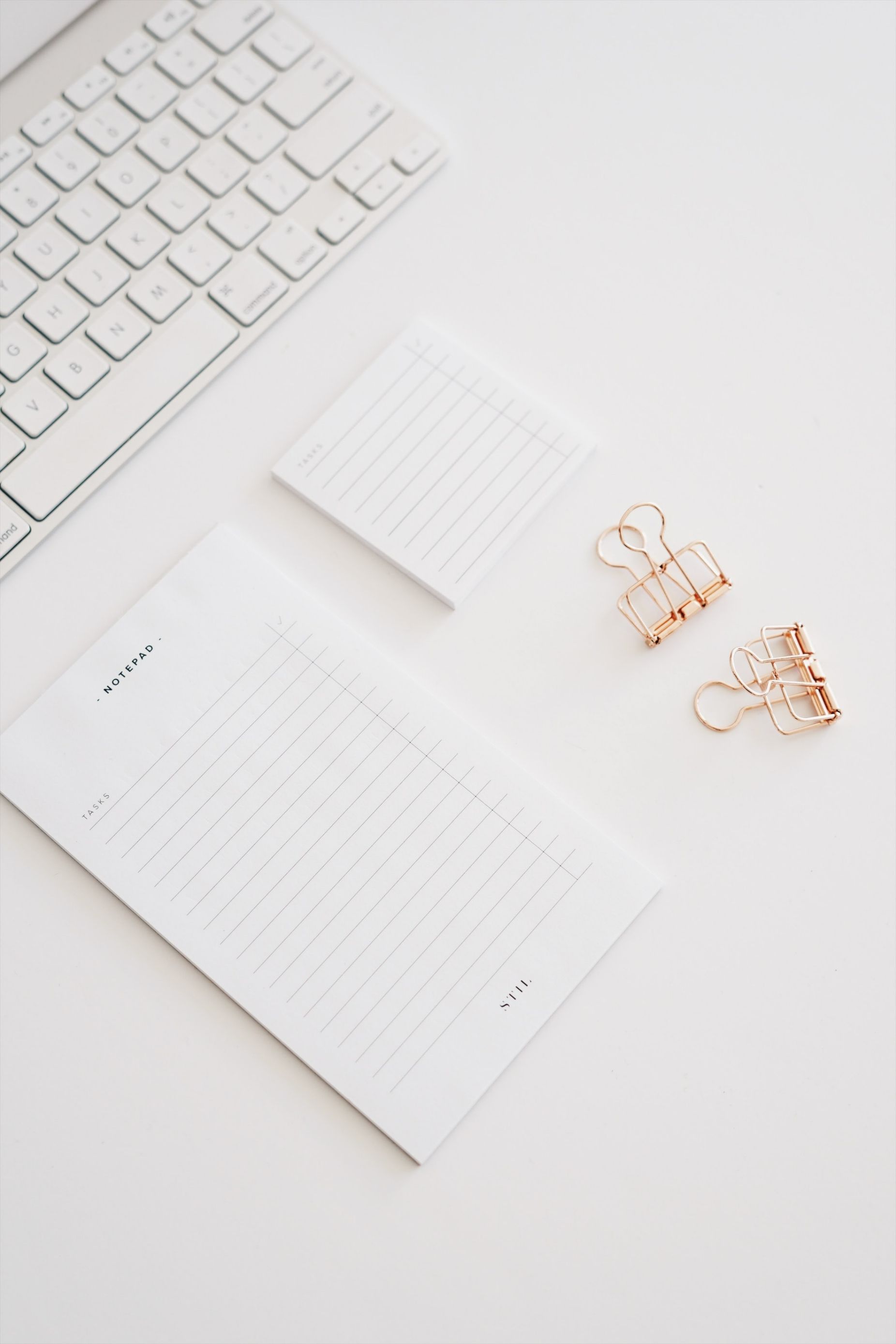 Notepad & Binder Clips On A White Table — Personalised Stationery in Dubbo, NSW
