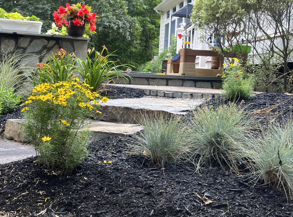 Mulch installation with new flower planting