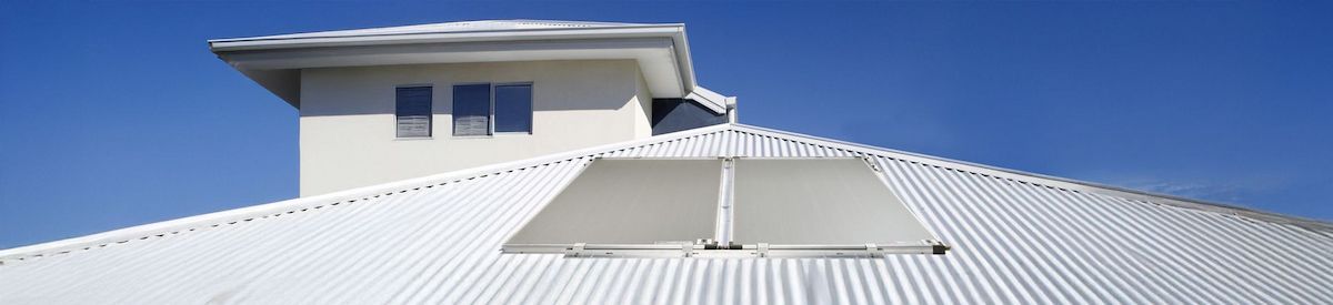 White Metal Roof With Rooftop Structure and Vents Against a Blue Sky — Forster Hotwater in Old Bar, NSW