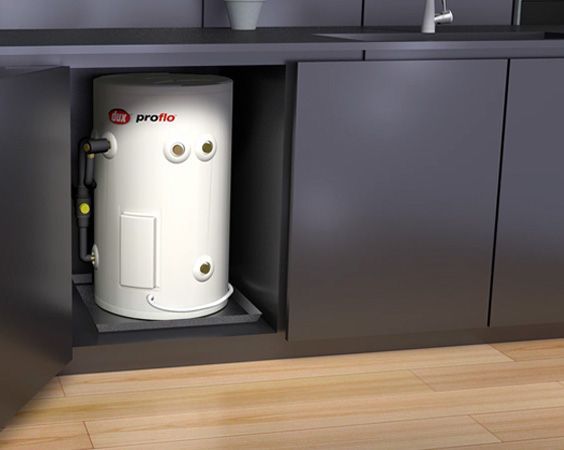 White Water Heater in a Gray Kitchen Cabinet Nook Beside a Wood Floor — Forster Hotwater in Hallidays Point, NSW
