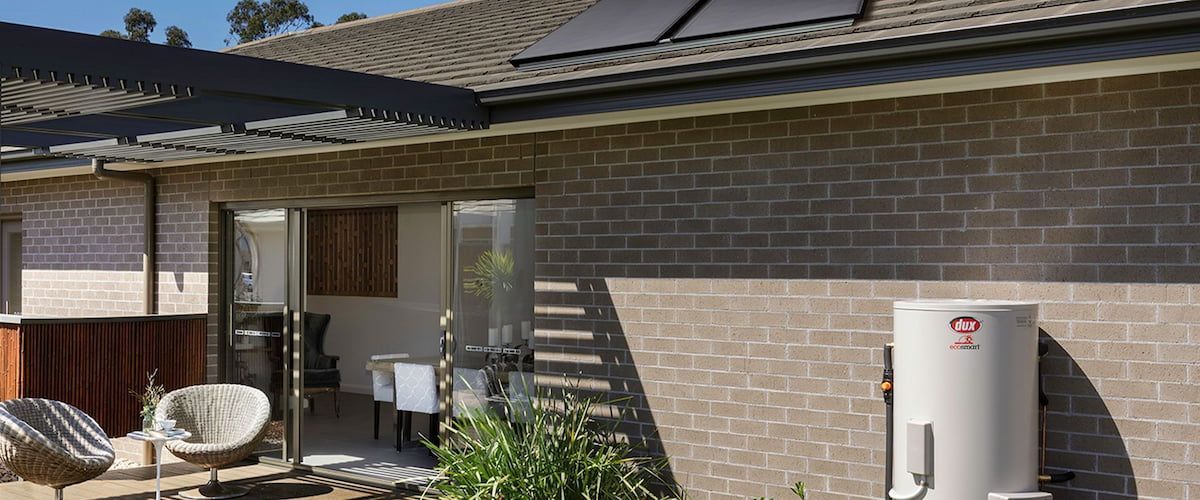 Backyard Patio With Outdoor Chairs and Solar Hot Water — Forster Hotwater in Forster, NSW