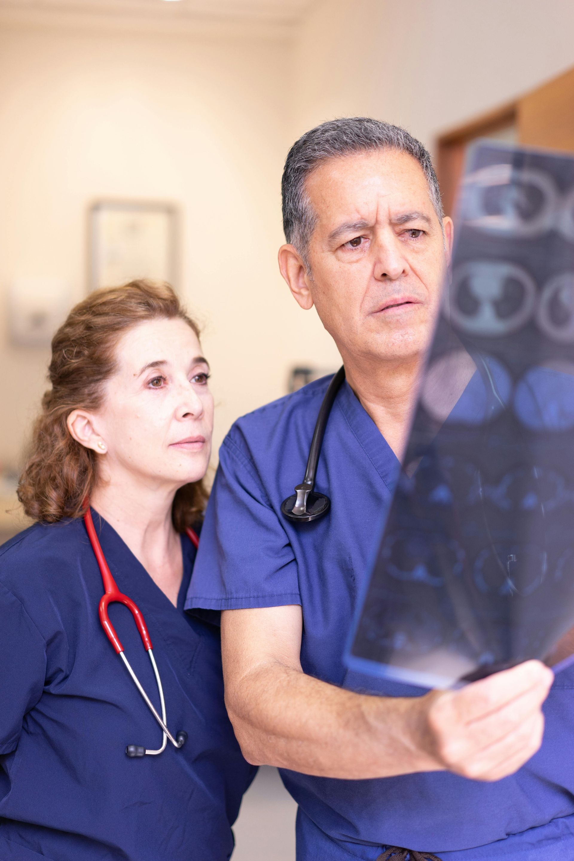 A man and a woman are looking at an x-ray together.