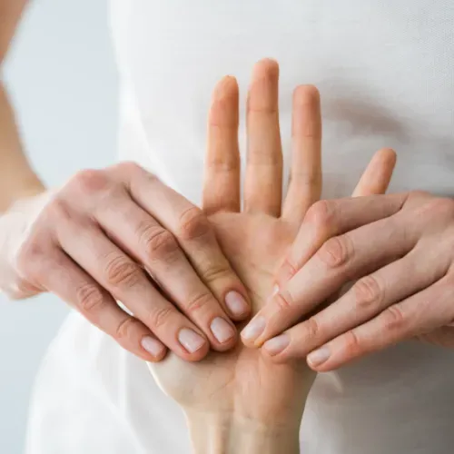 A close up of a person 's hands on another person 's hand