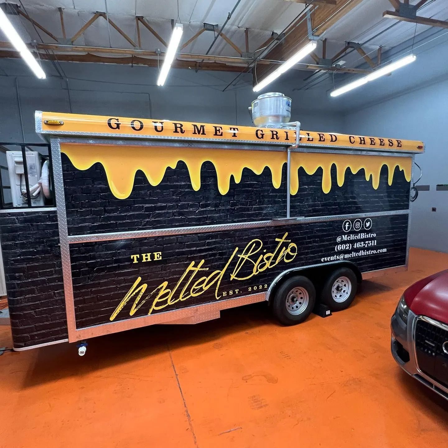 Grilled cheese food truck, black with yellow dripping cheese design, 