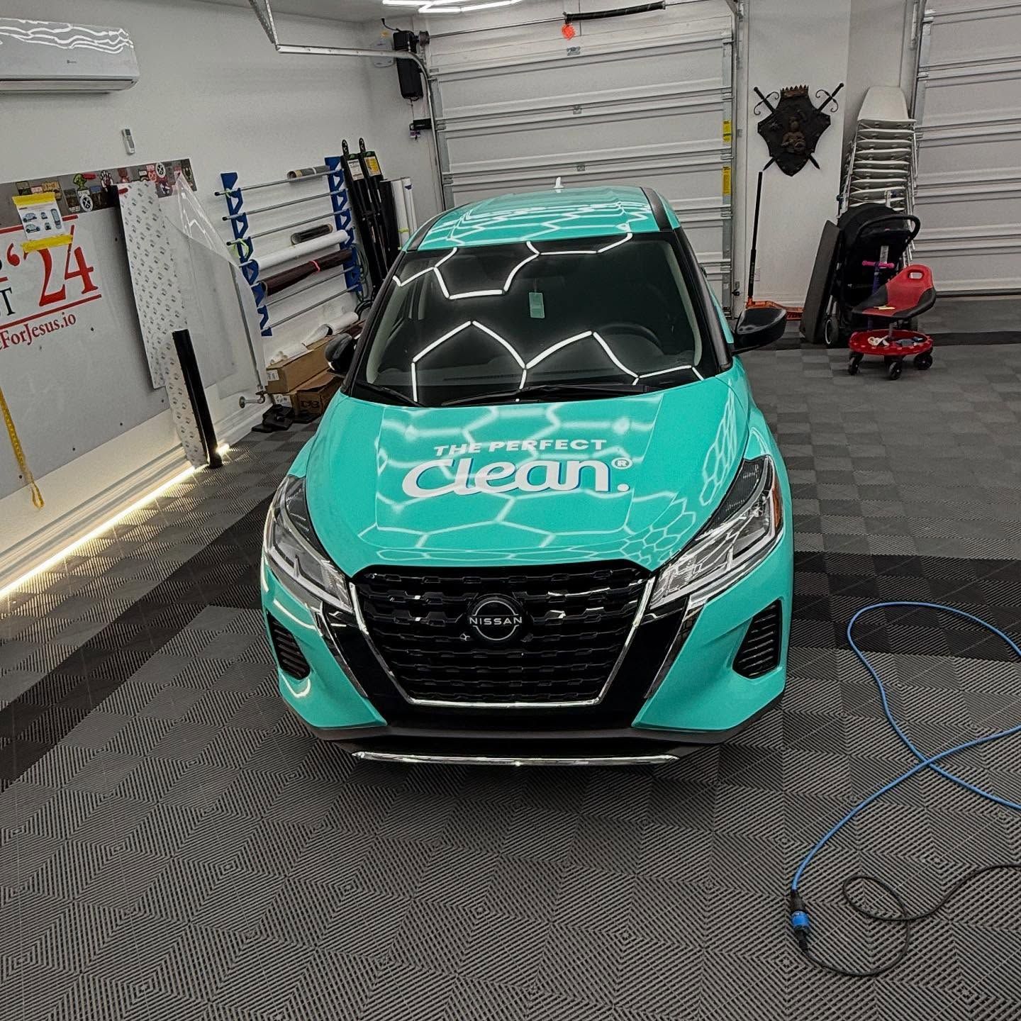 A turquoise Nissan SUV with 